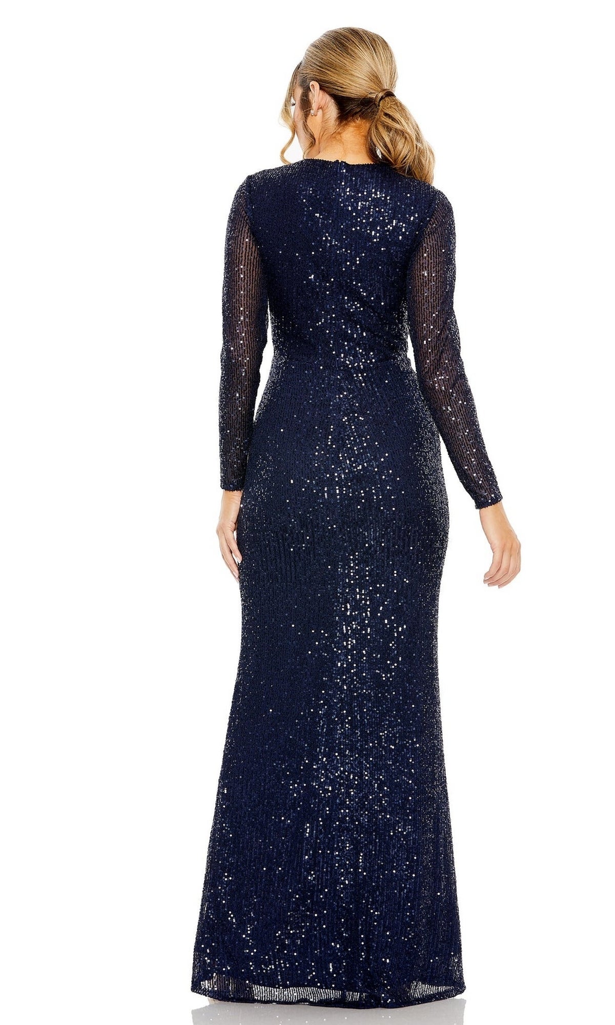 A woman with light brown hair in a low ponytail wears the Mac Duggal 11659 Long Sleeve Sequin Formal Dress, a floor-length navy blue evening gown, shown from the back.